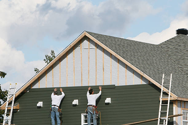 Professional Siding Installation technician working in Millis, MA